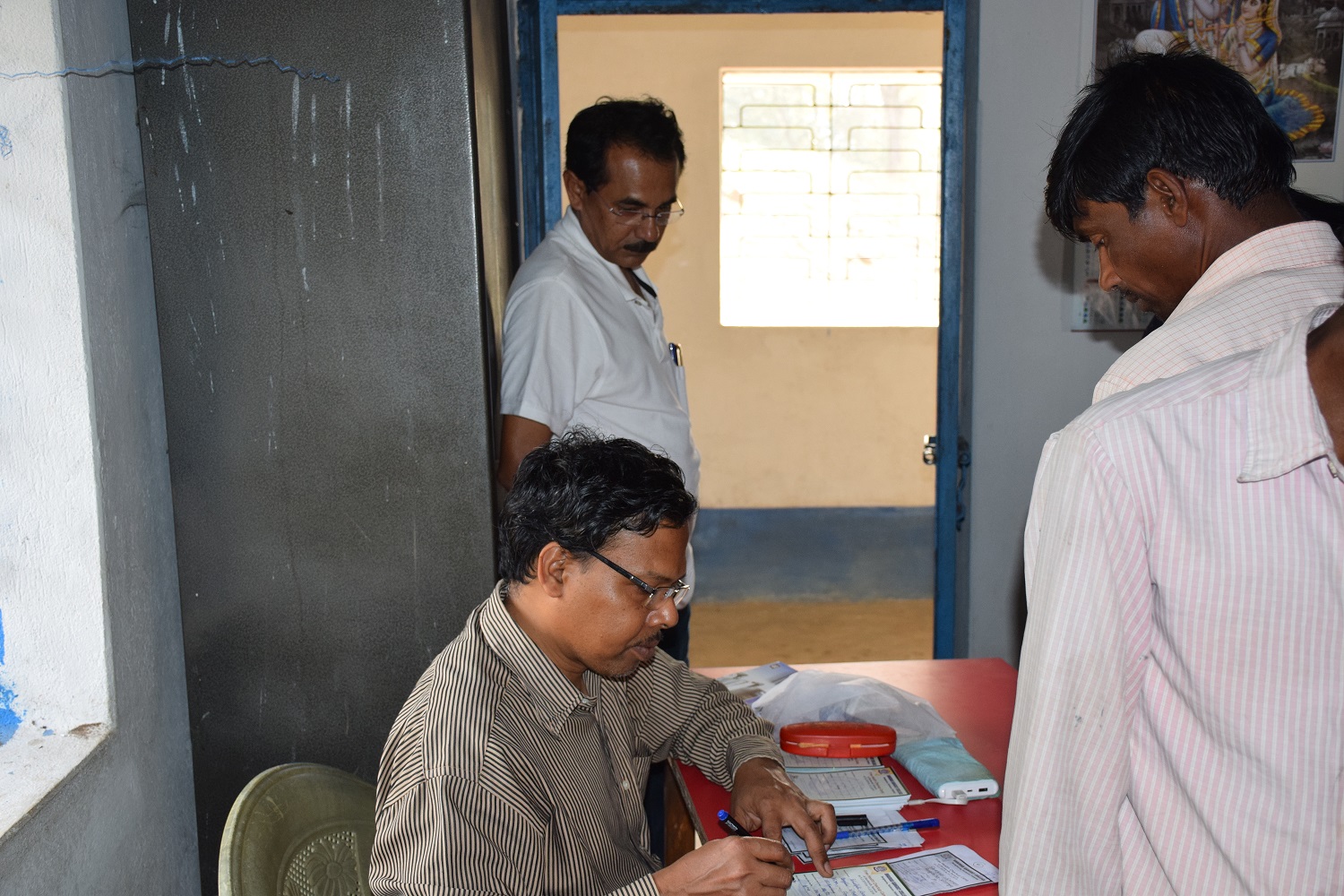 Doctor Prescribing the patient during Health Camp organized by College